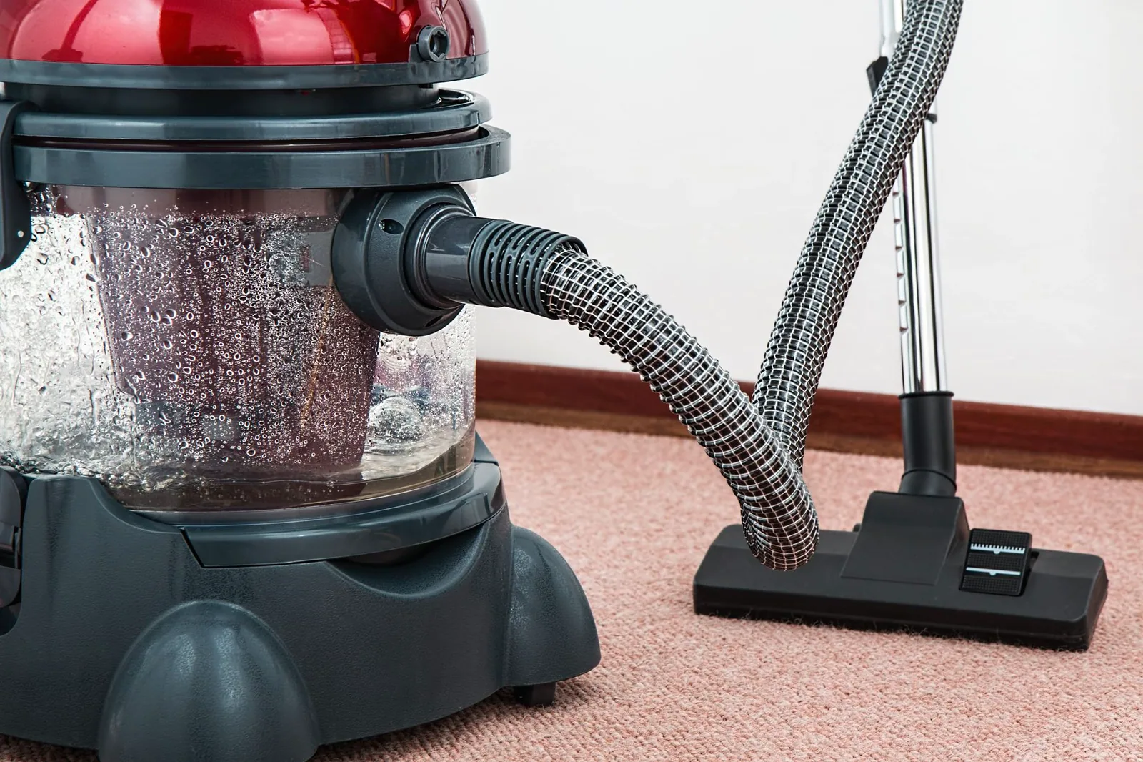 Water extraction equipment pulling water out of a soaked carpet