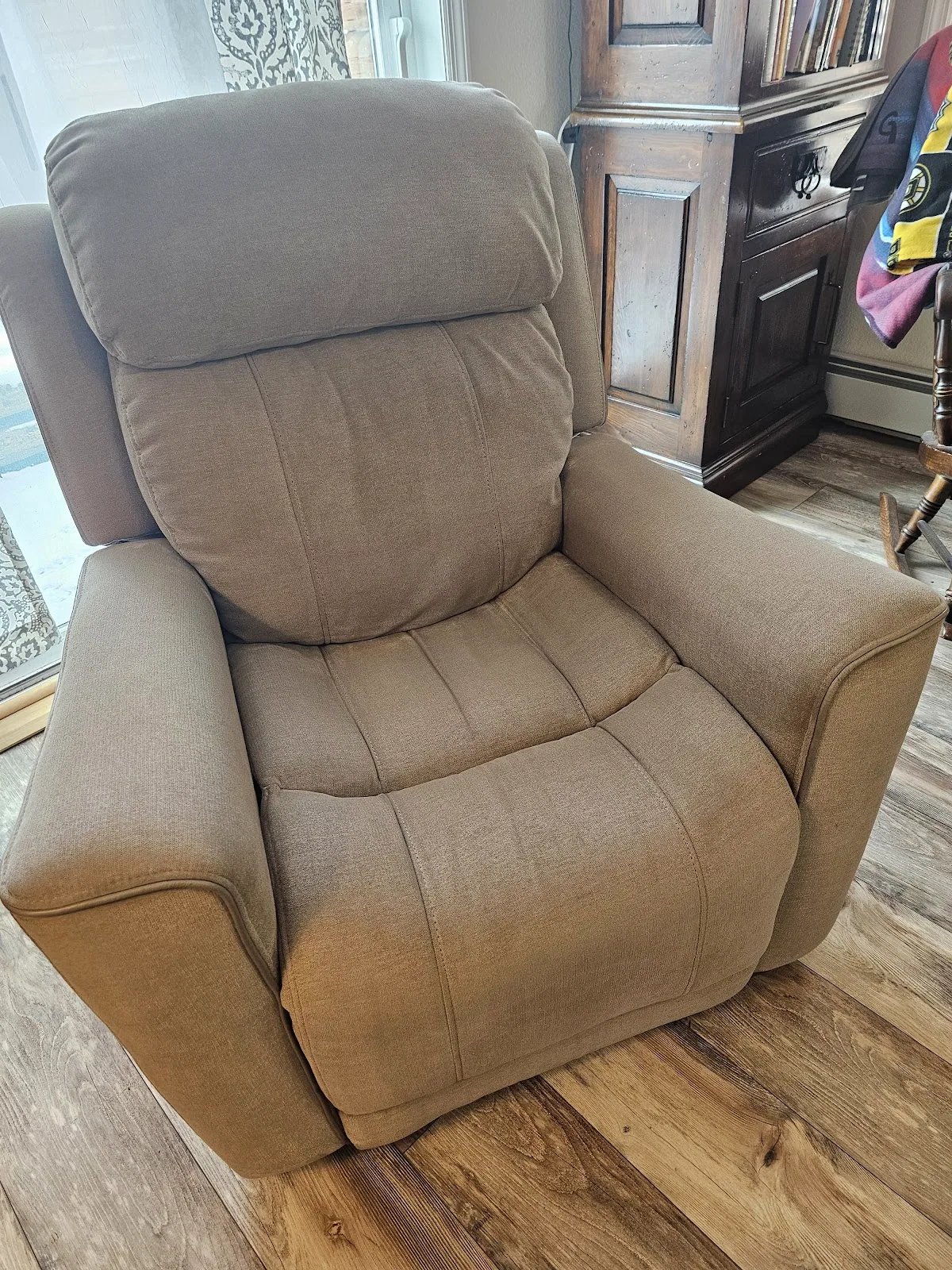 A cleaned tan fabric power recliner